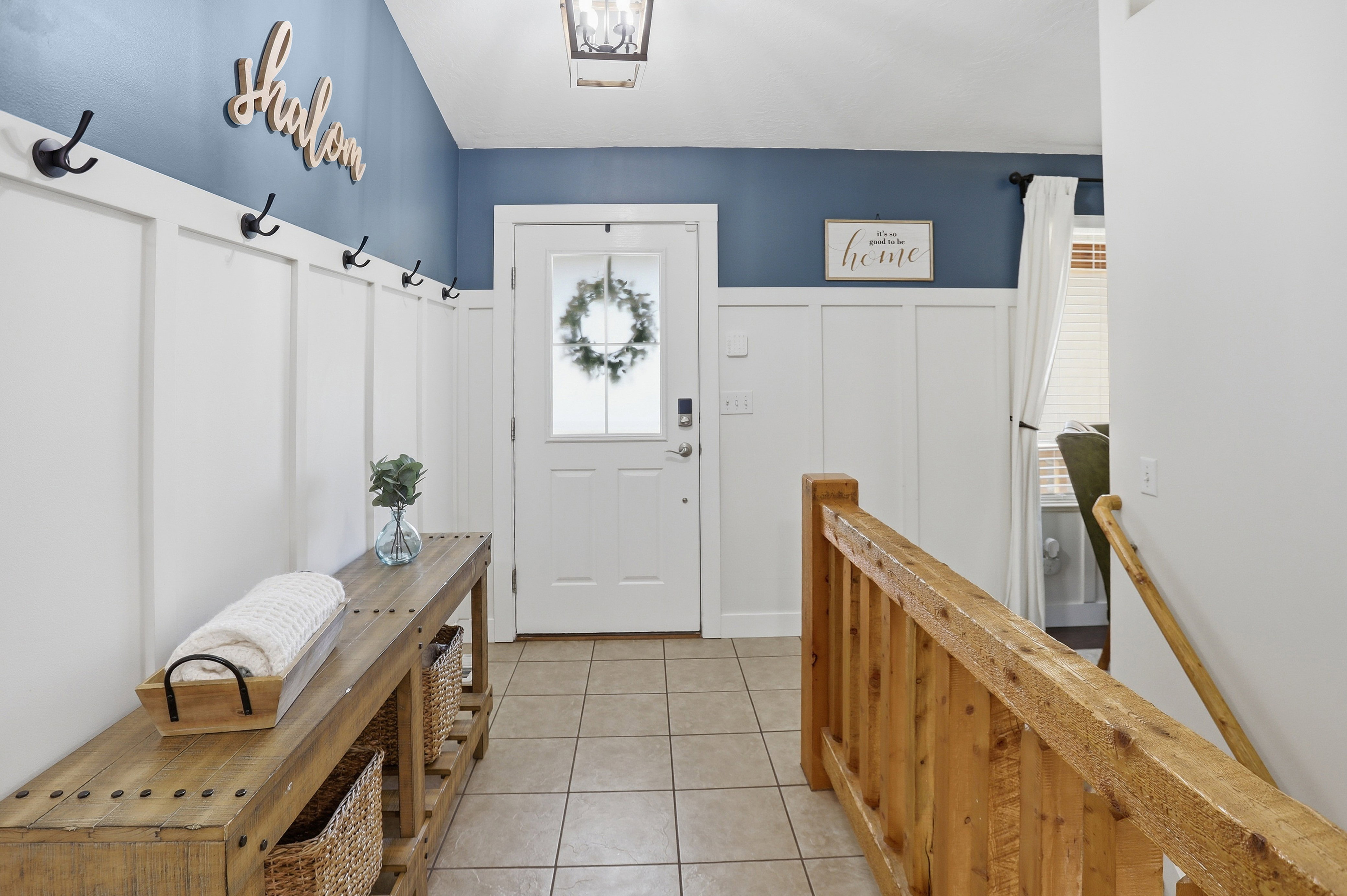 Entryway featuring board and batten wall paneling, a full light front door, and ceramic tile flooring