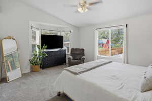 Carpeted master bedroom featuring a bay window with natural light, white painted walls, and a ceiling fan