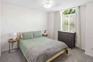 Arched window with blinds and white drapes