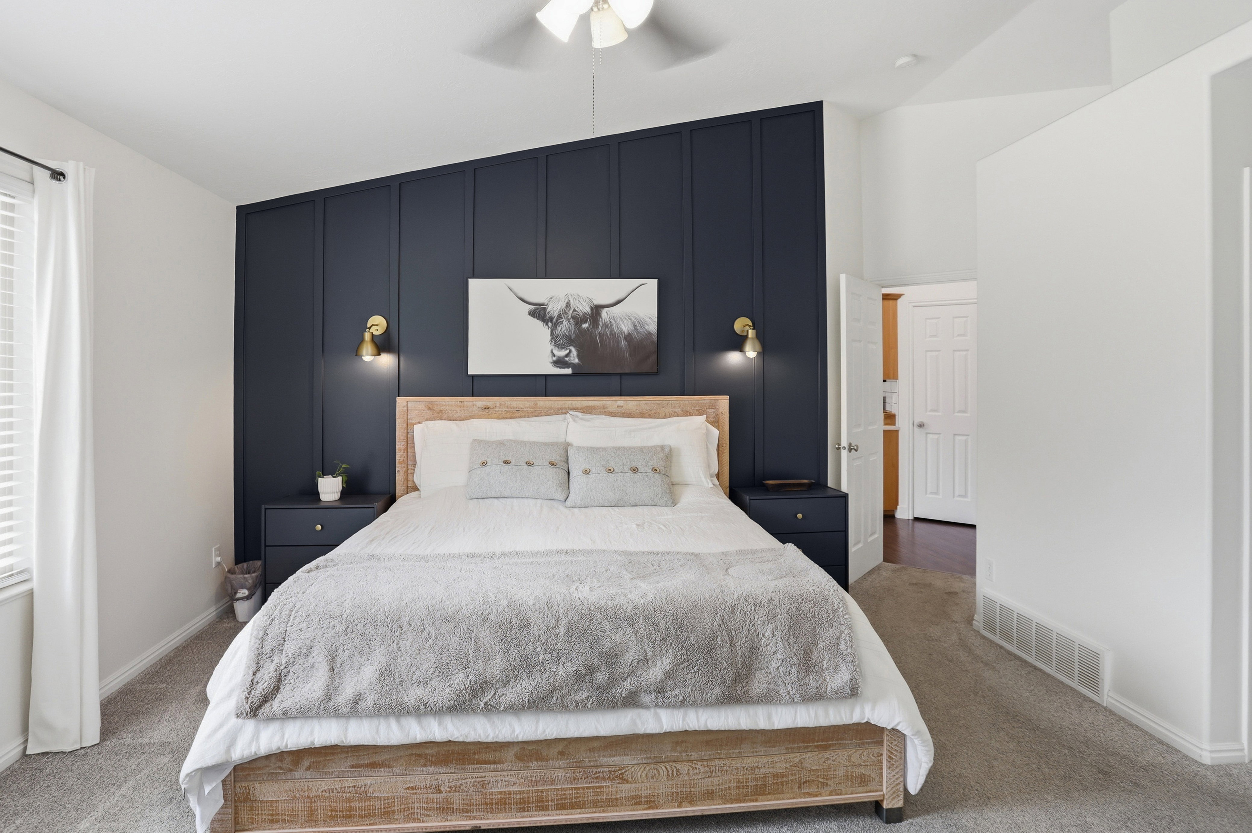 Accent wall featuring vertical paneling in master bedroom