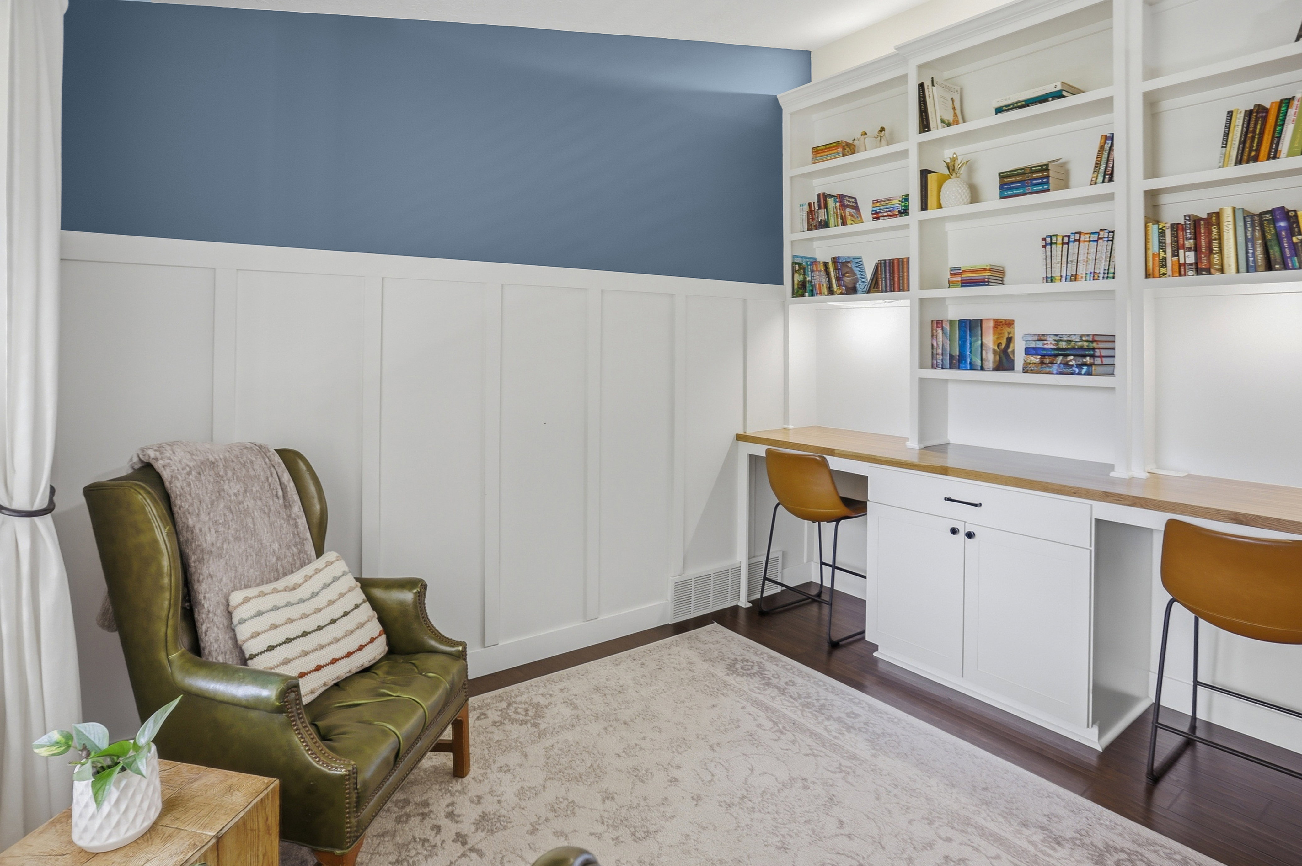 Built-in shelving with integrated desk space and task lighting