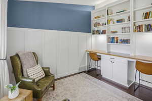 Built-in shelving with integrated desk space and task lighting
