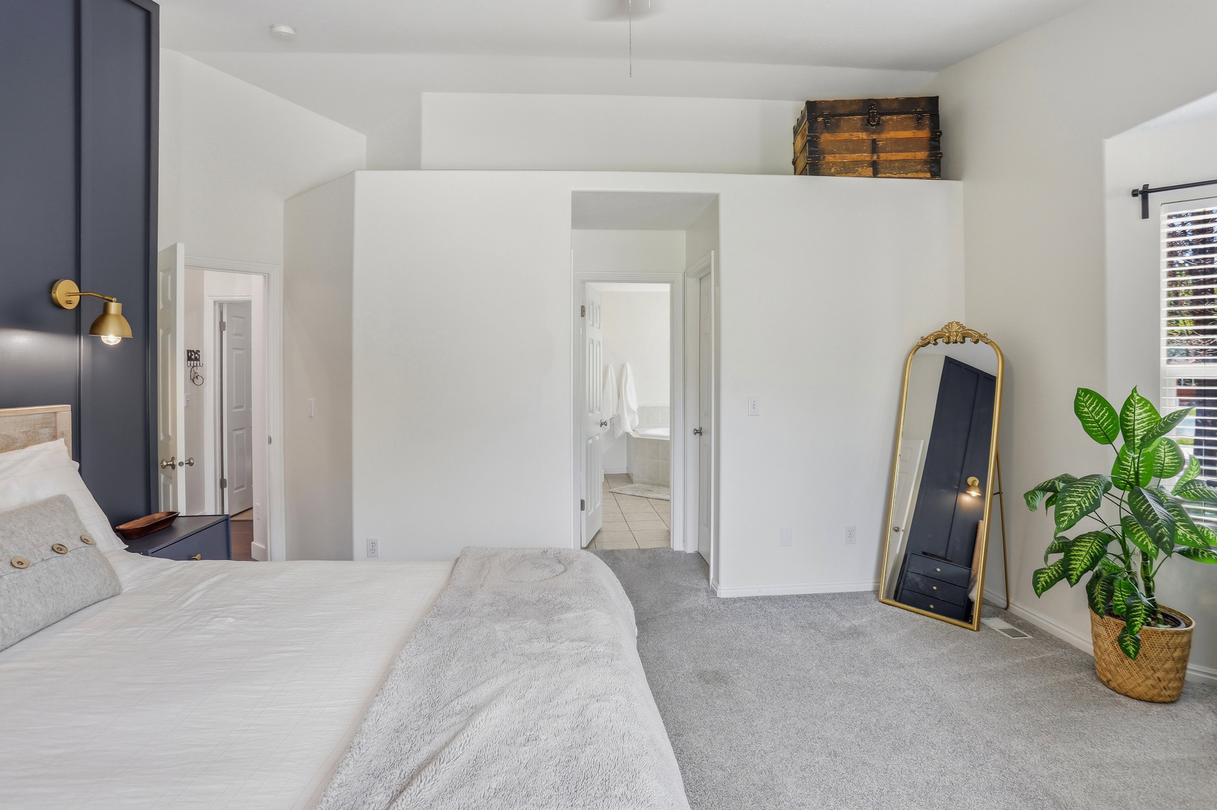Spacious room featuring light gray carpeting and white walls