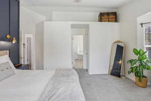 Spacious room featuring light gray carpeting and white walls
