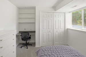 Built-in desk with a stone-finish countertop and open shelving