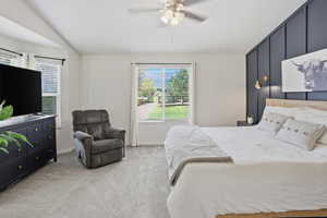 Bedroom featuring a board and batten accent wall, light wood-finish headboard, and dual wall-mounted brass sconces