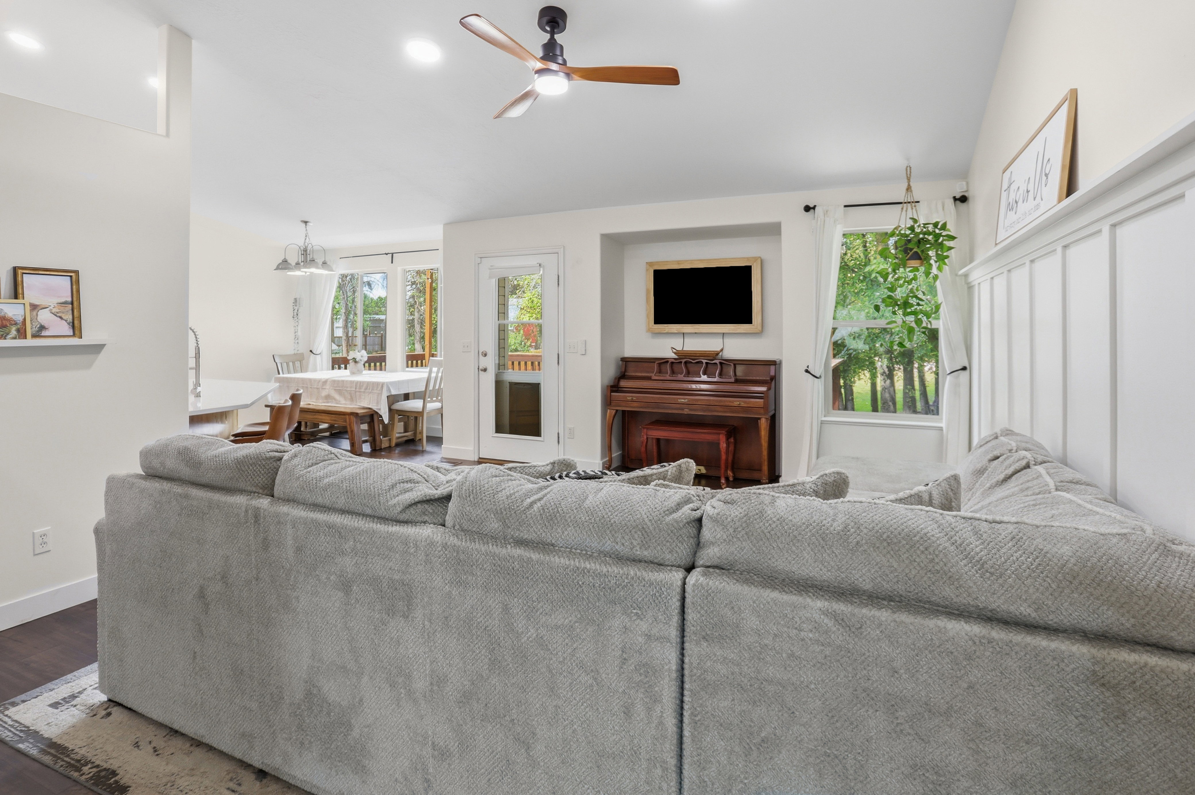 Spacious living area featuring high ceilings, recessed lighting, and wood-finish flooring