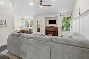 Spacious living area featuring high ceilings, recessed lighting, and wood-finish flooring