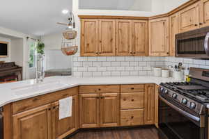 Kitchen featuring wood-finish cabinetry, white countertops, and subway tile backsplash