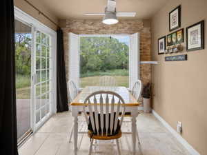 Dining area with tile flooring and a ceiling fan light fixture