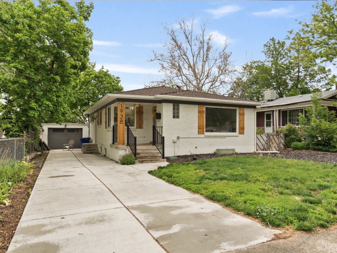 White exterior with wood shutters and dark trim