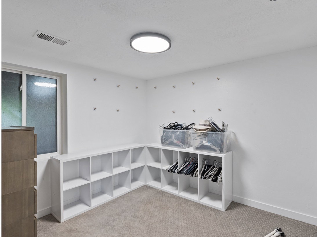 Interior space featuring white walls and a light-colored carpet