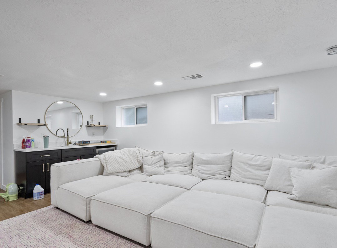 Spacious entertainment room featuring recessed lighting and wood-finish flooring