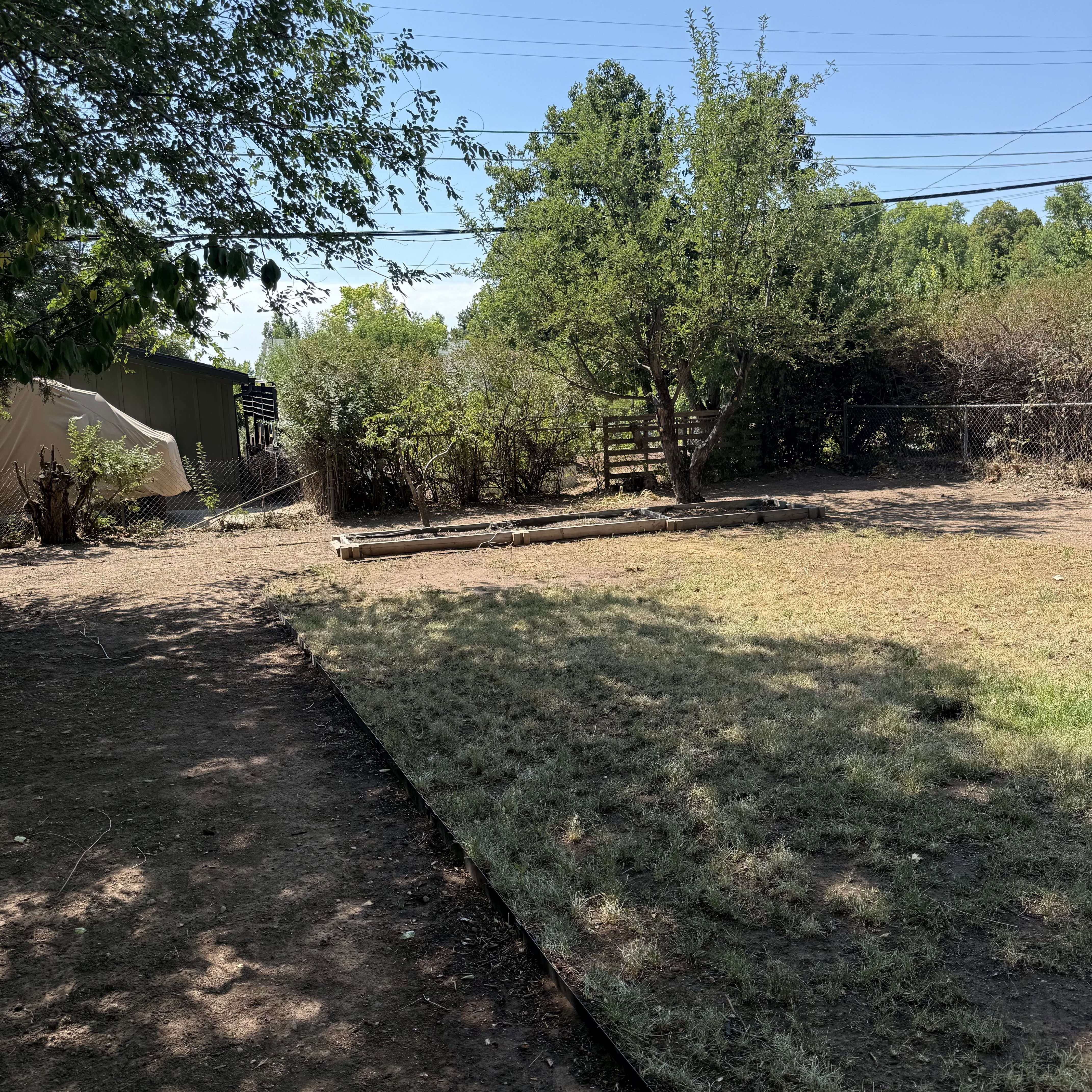 Expansive outdoor space featuring a combination of natural ground cover and a grass area