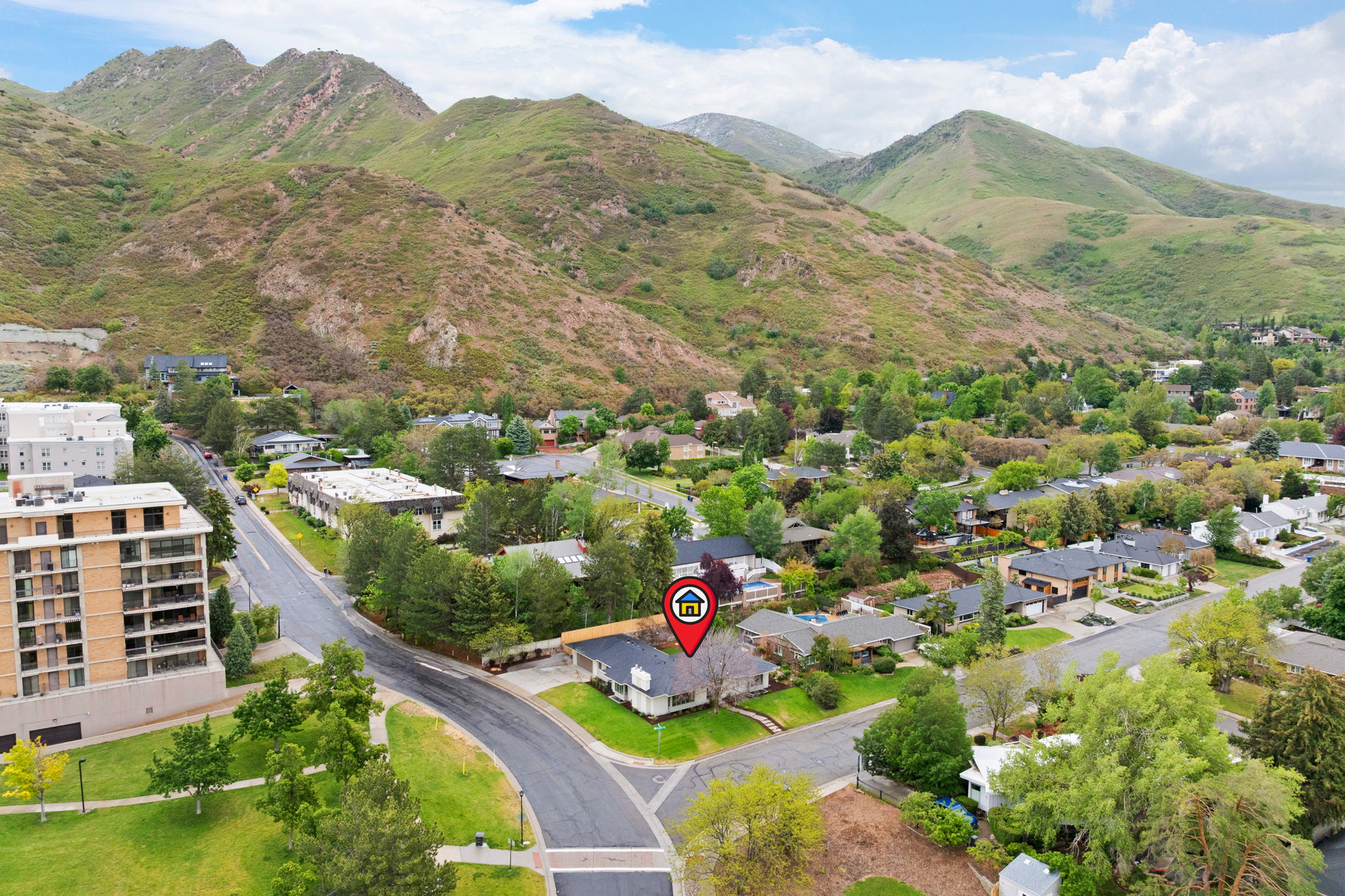 Aerial perspective showcasing a residential neighborhood with mountainous terrain