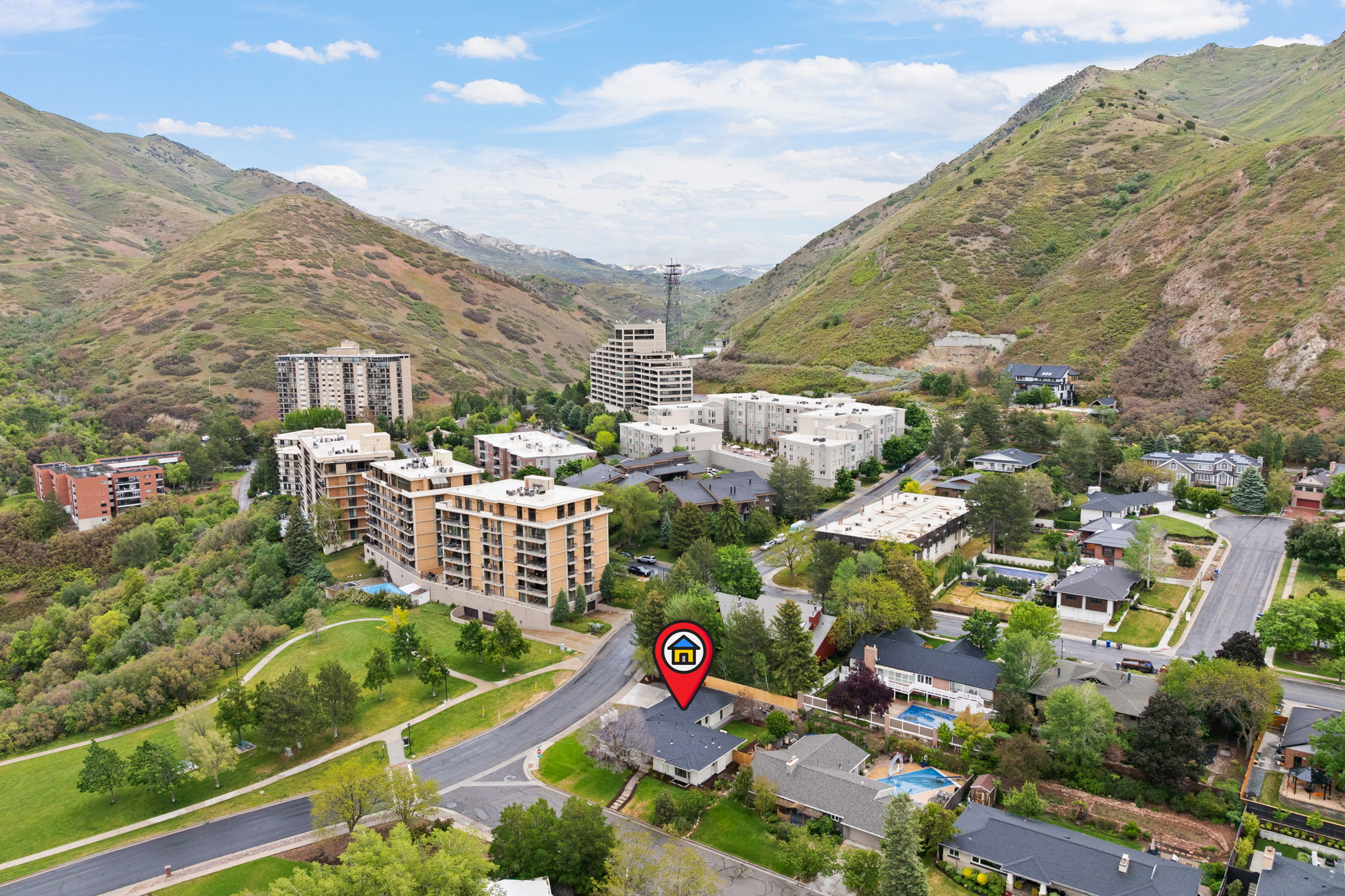 Aerial perspective of a property nestled within a mountainous landscape