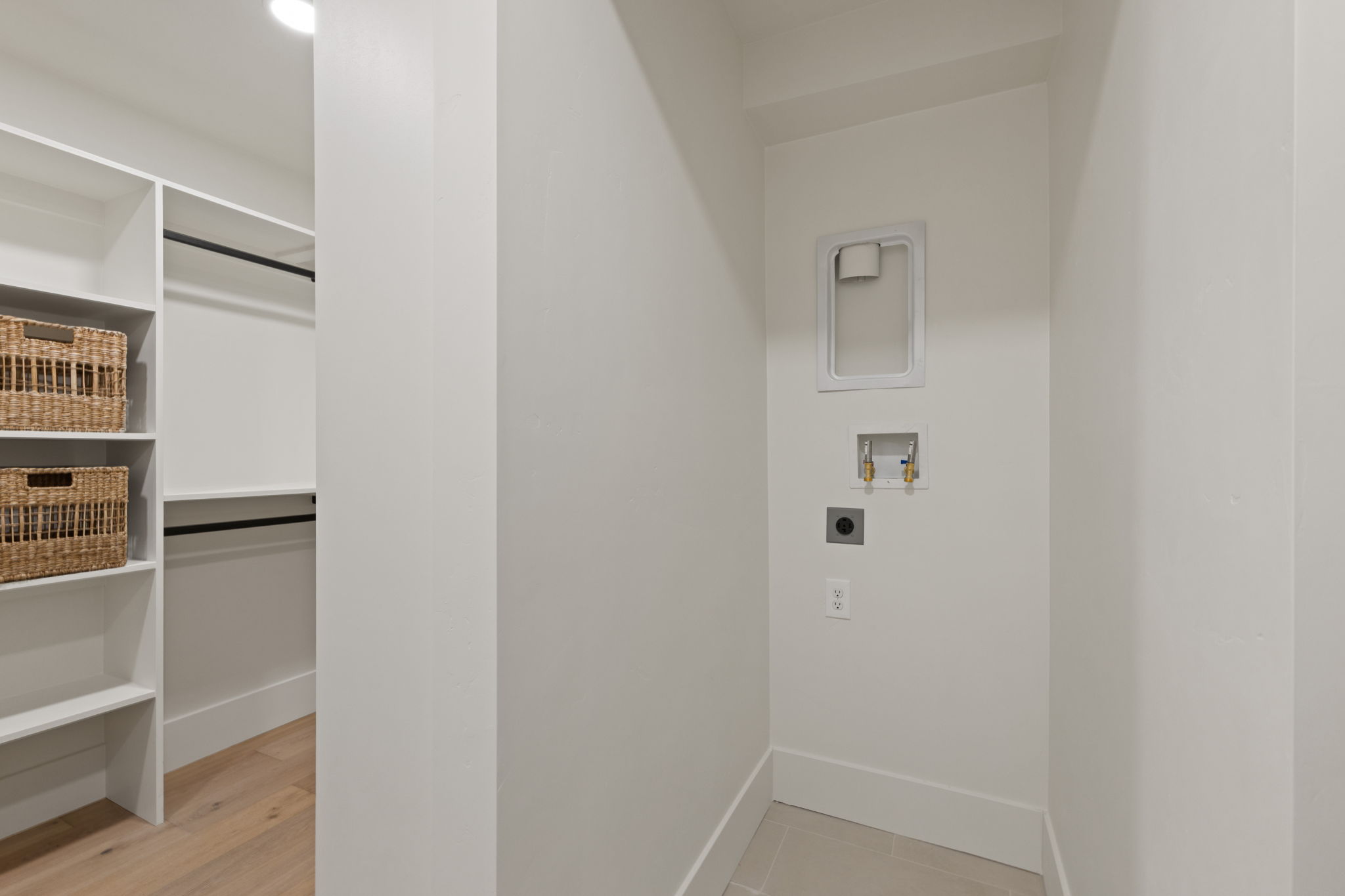 Dedicated laundry area with utility hookups and neutral tile flooring