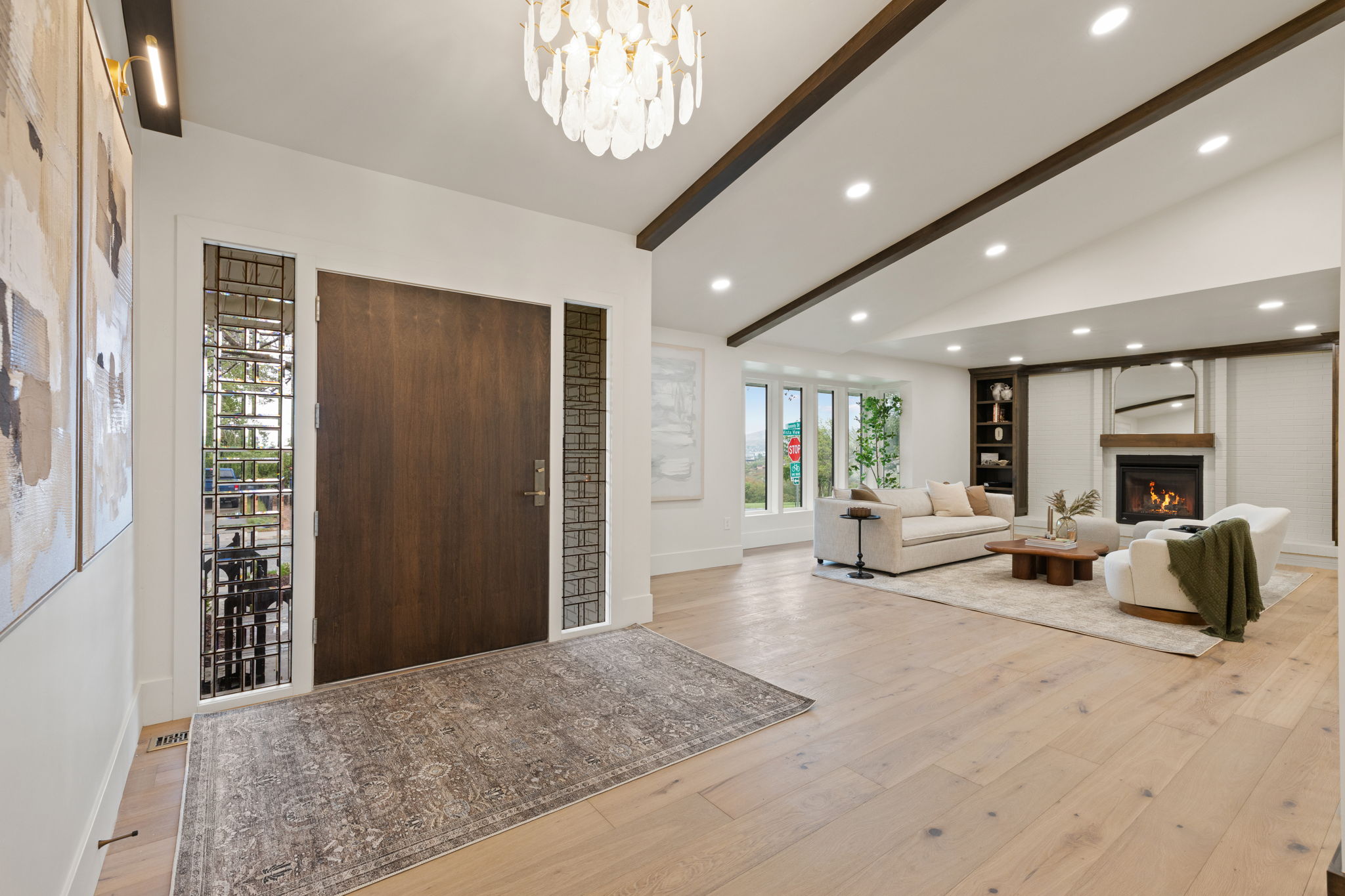 Grand entry with a solid wood door and sidelight windows, opening to an expansive living area