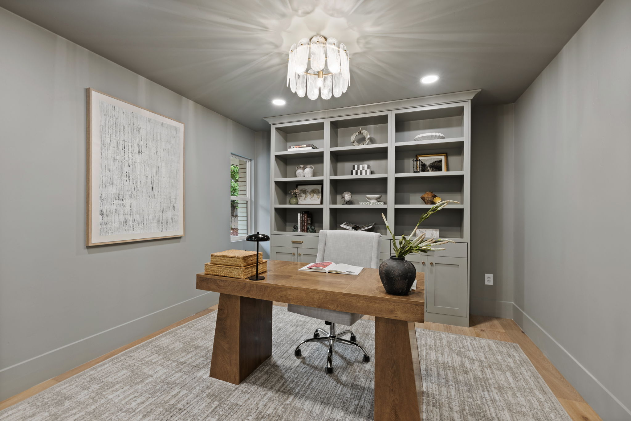 Integrated built-in shelving with lower cabinetry provides ample storage