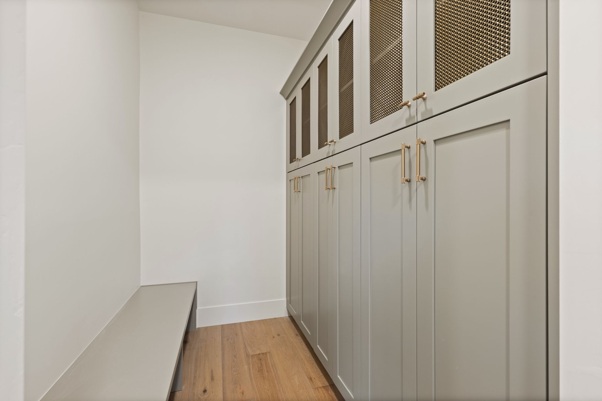 Custom built-in cabinetry with paneled doors and gold-finish hardware