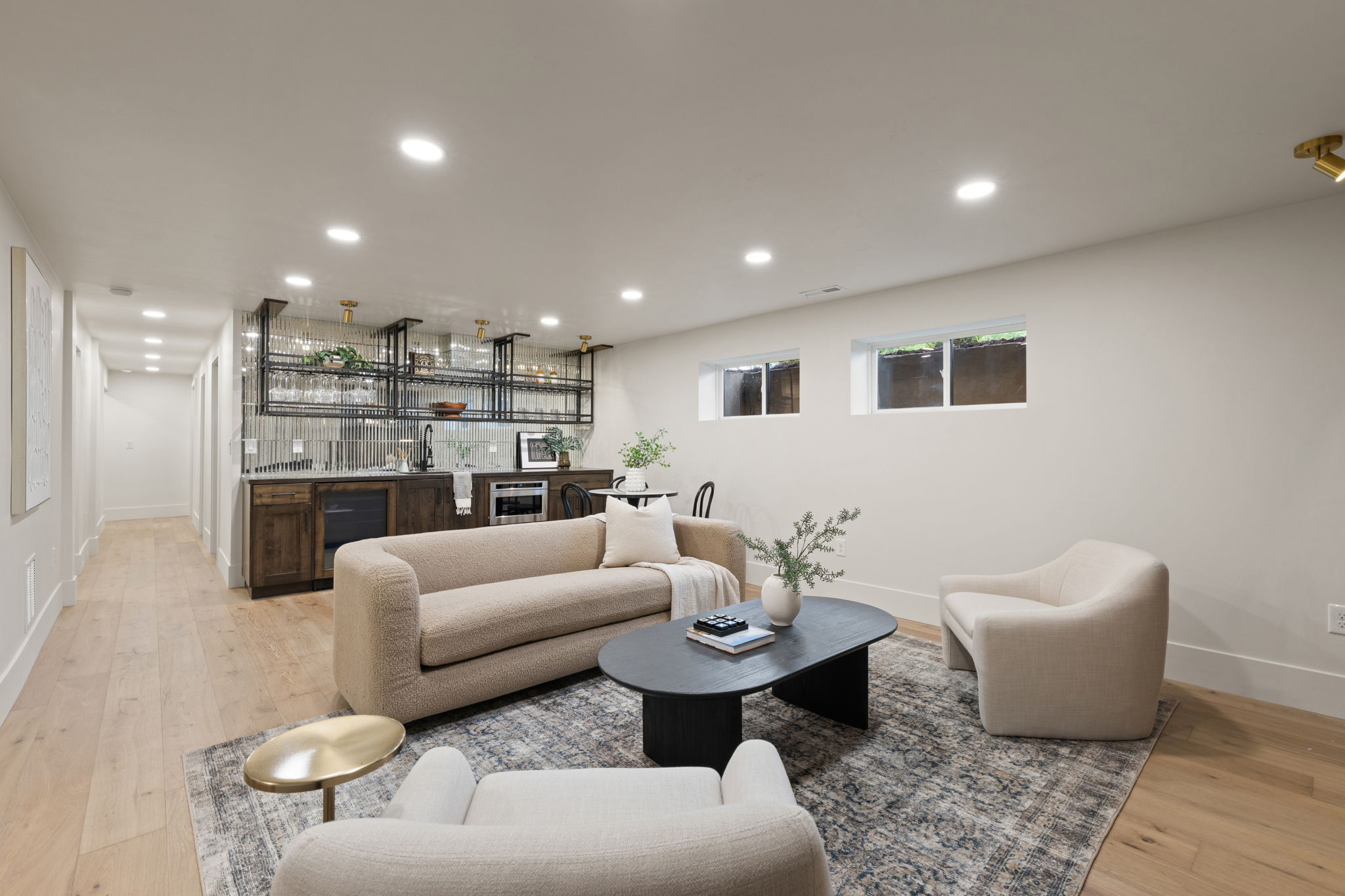 Entertaining space featuring a built-in wet bar with dark wood cabinetry, beverage refrigerator, and overhead shelving