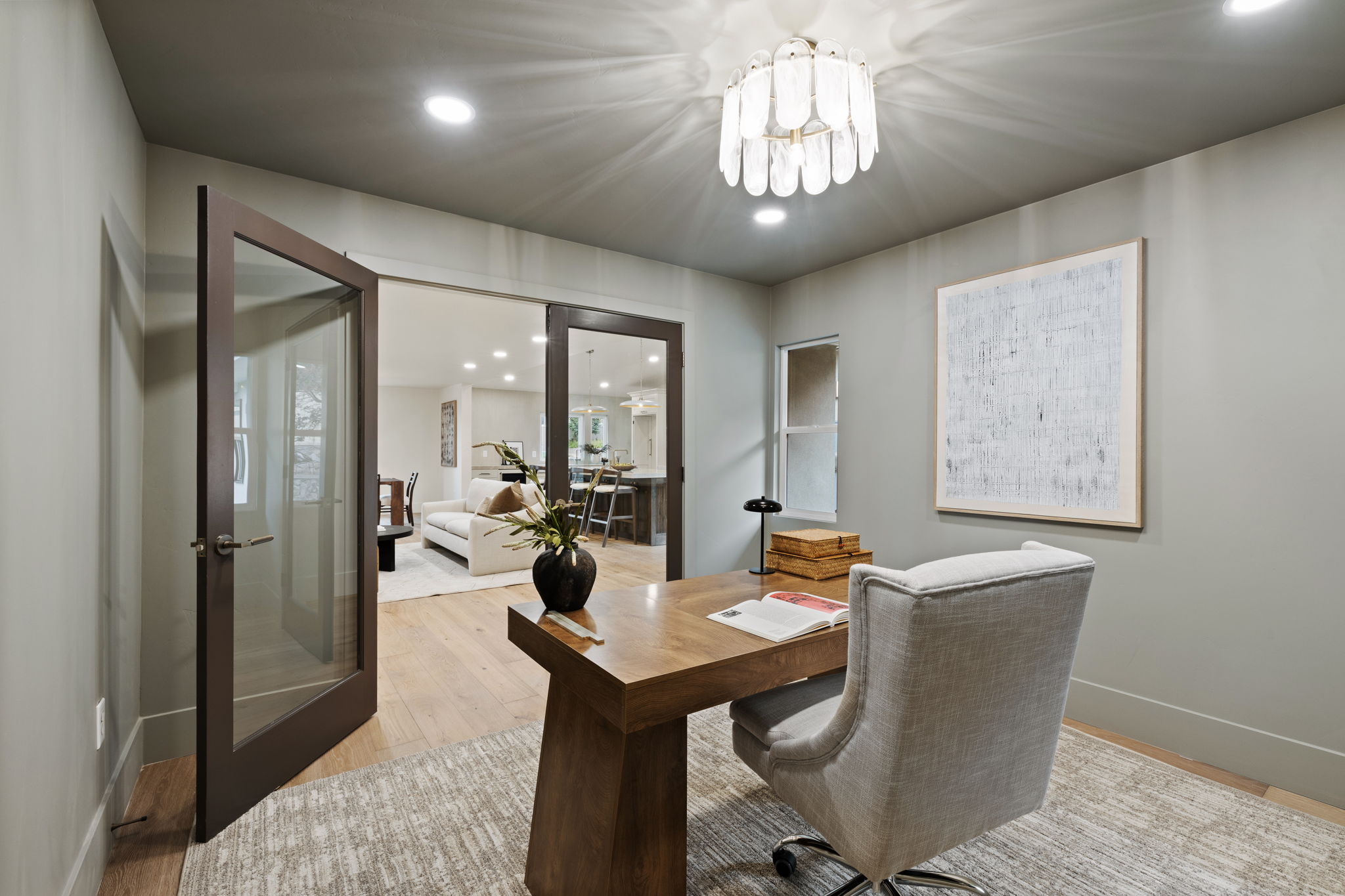 Dedicated room featuring wood-finish flooring, recessed lighting, and a modern chandelier