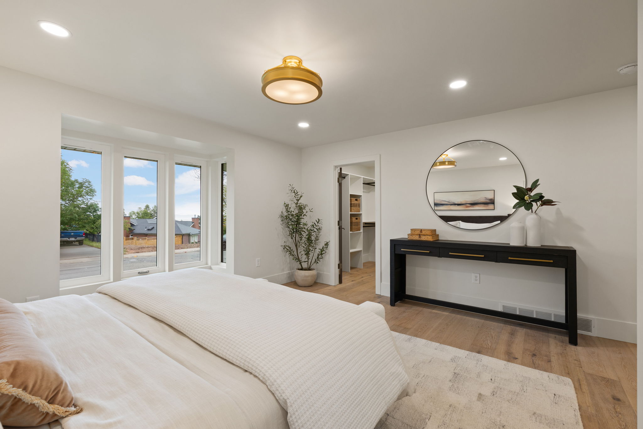 Spacious room featuring wood-finish flooring, recessed lighting, and a prominent bay window