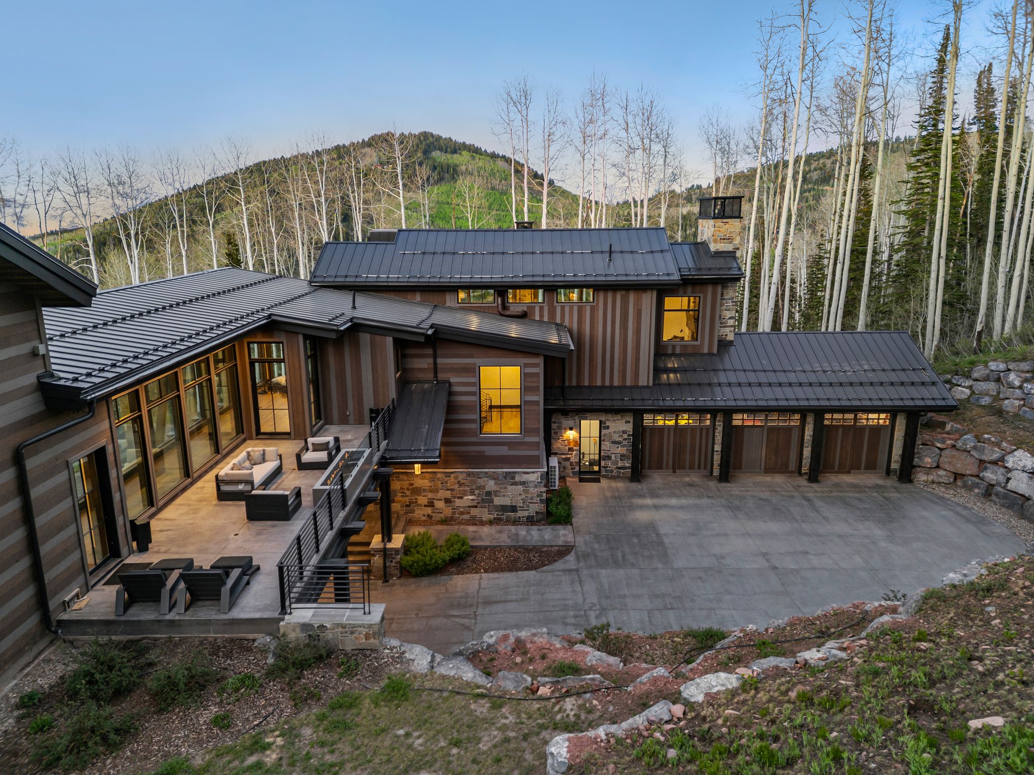 Modern architectural exterior featuring wood-finish siding and stone accents