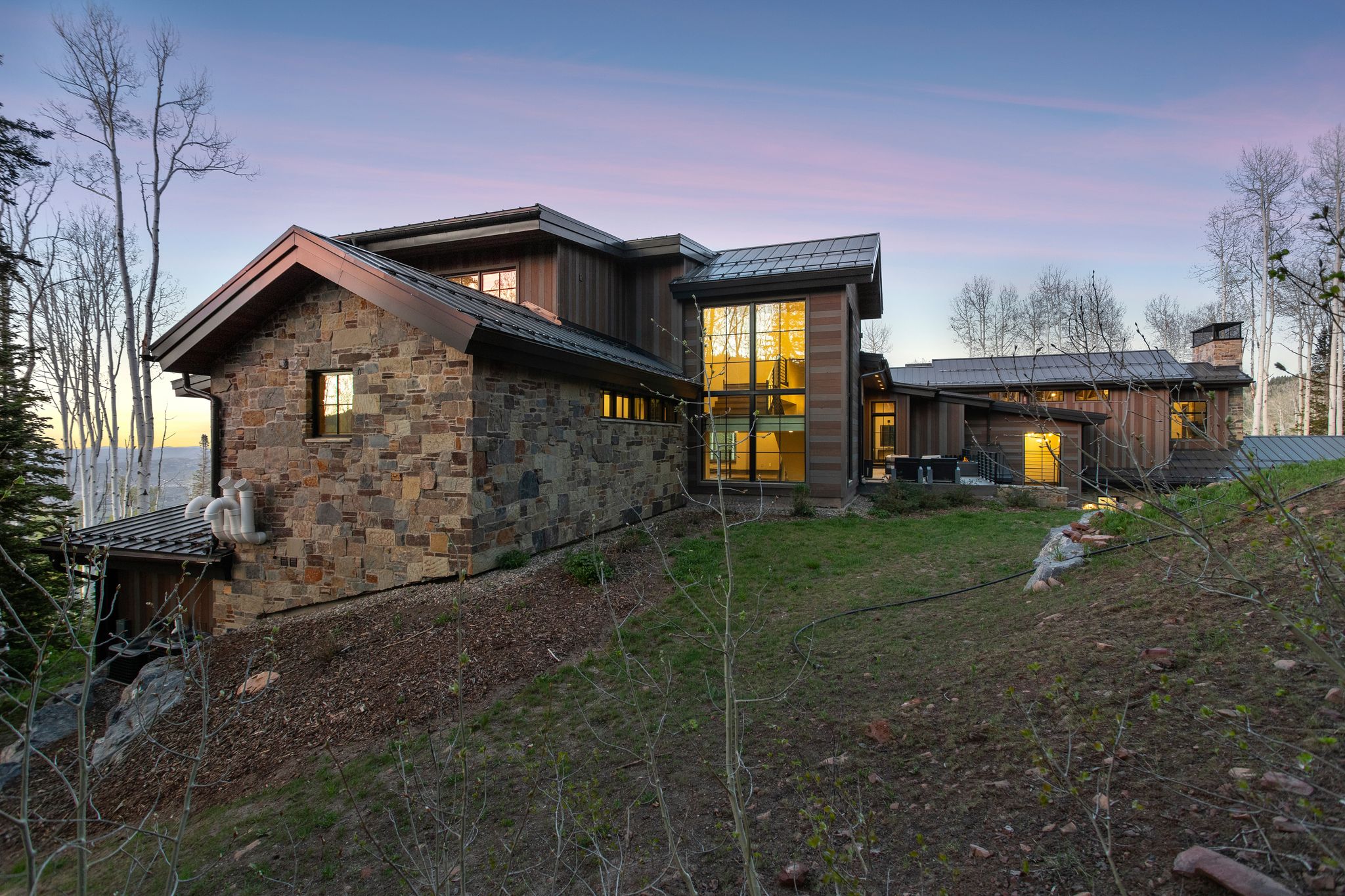 Stone and wood-clad exterior with a multi-level architectural design
