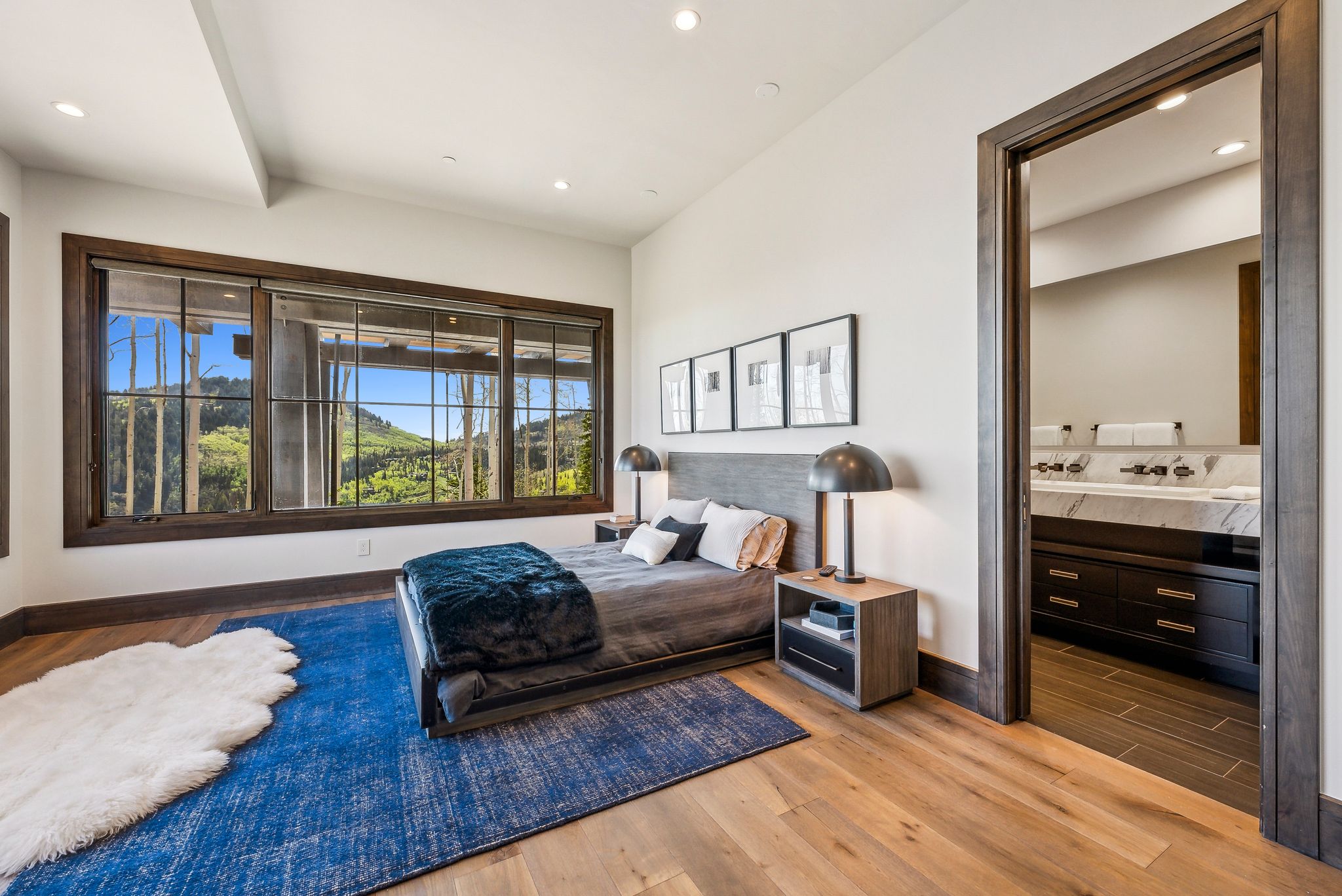 Expansive window wall with dark wood trim, offering a broad scenic backdrop