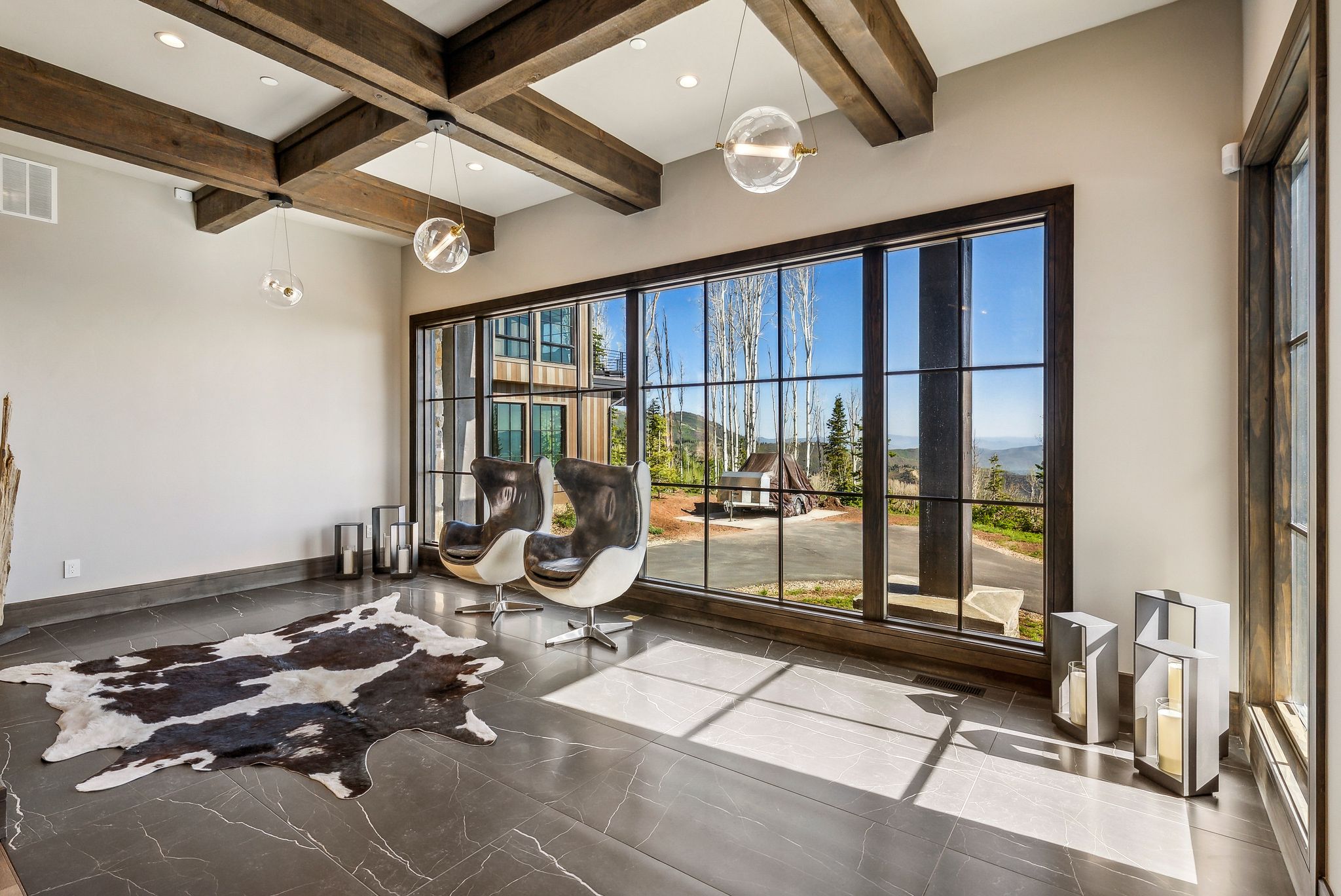 Expansive window wall with dark framing, showcasing exterior scenery
