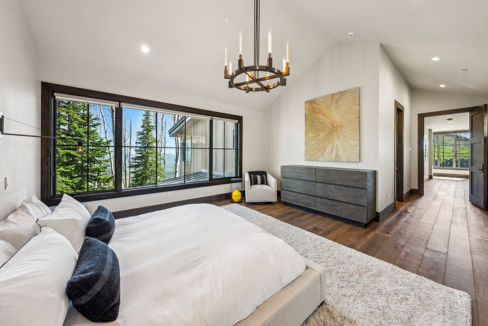 Vaulted ceilings and expansive windows frame the surrounding natural landscape