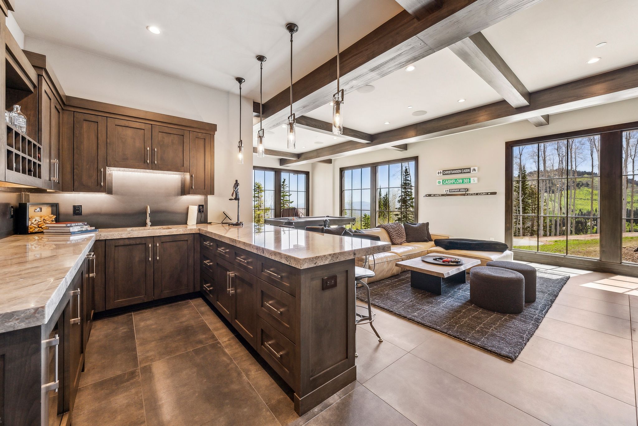 Kitchenette featuring rich wood cabinetry, stone countertops, and under-cabinet lighting