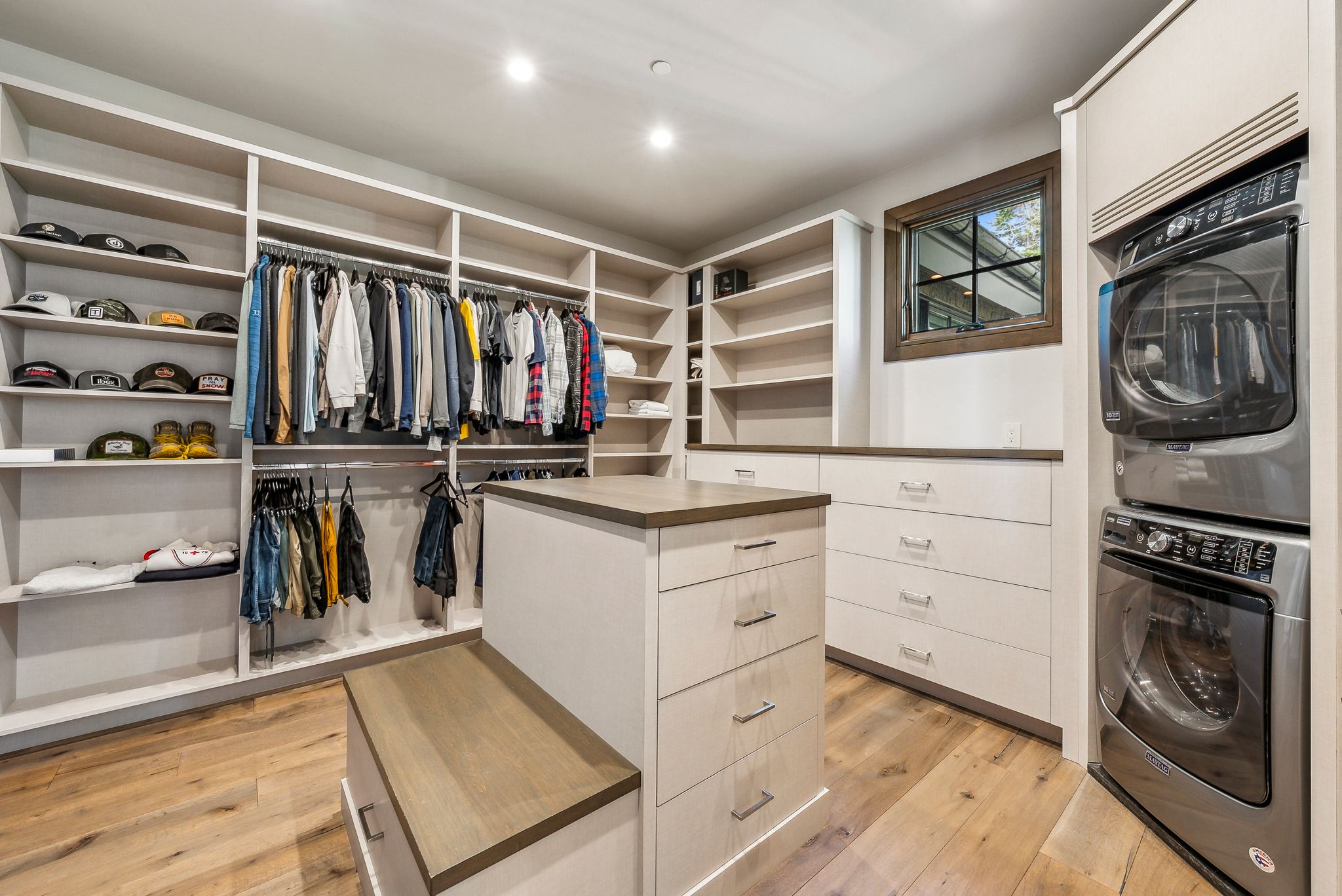Custom closet system featuring extensive shelving, multiple hanging rods, and built-in drawers