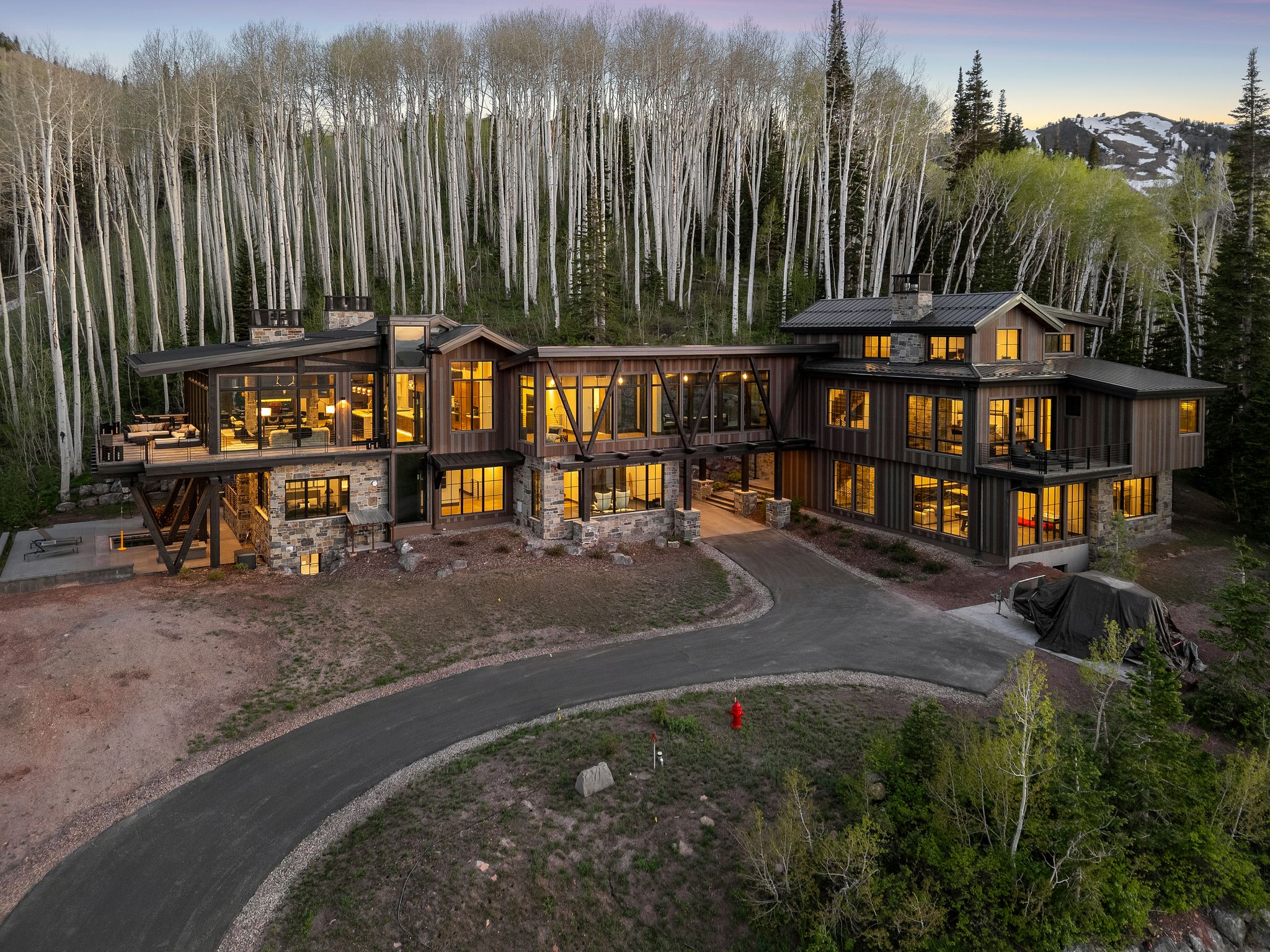 Contemporary mountain residence featuring extensive natural wood siding and stone accents