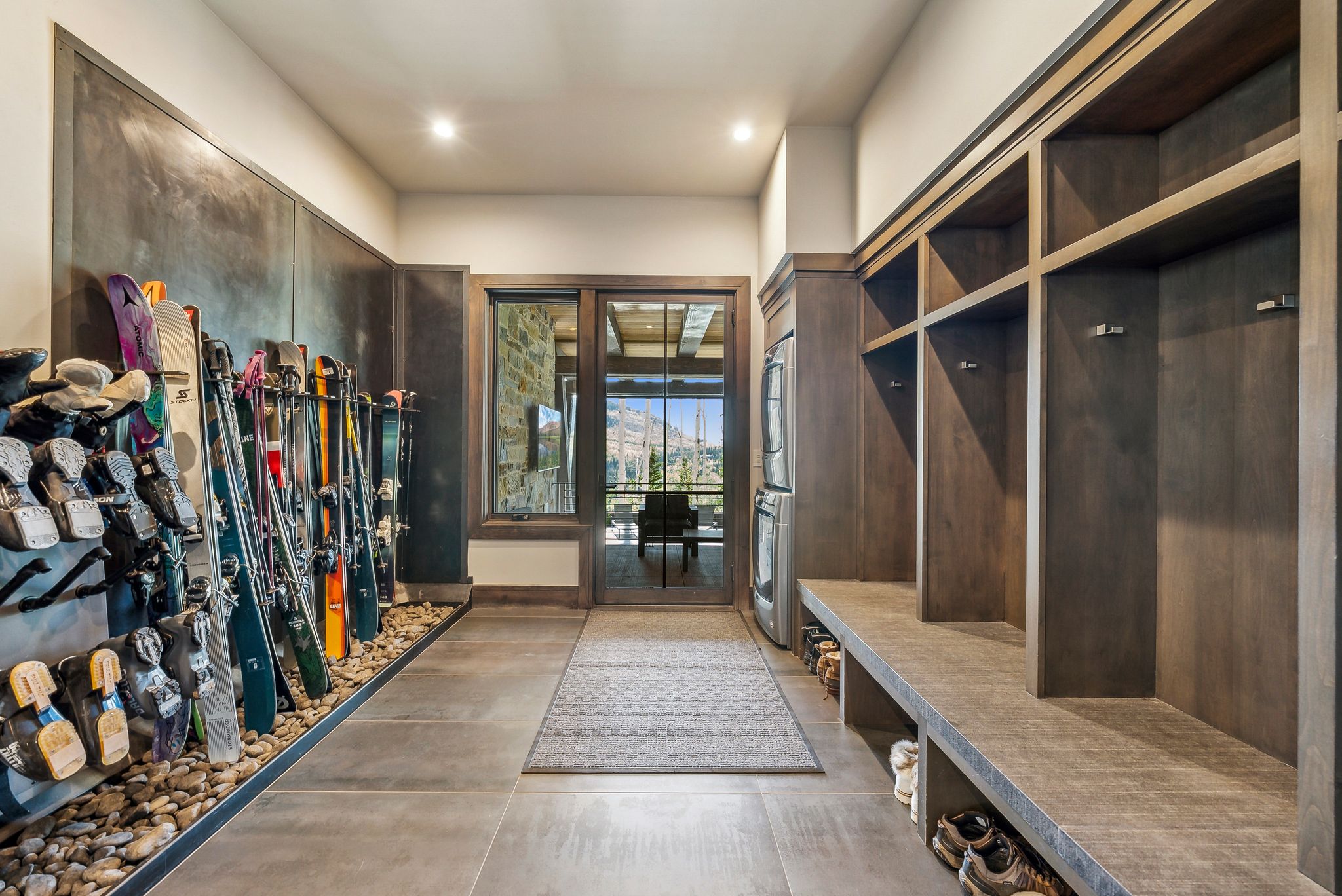 Mudroom featuring extensive built-in wooden lockers, integrated bench seating, and dedicated storage compartments