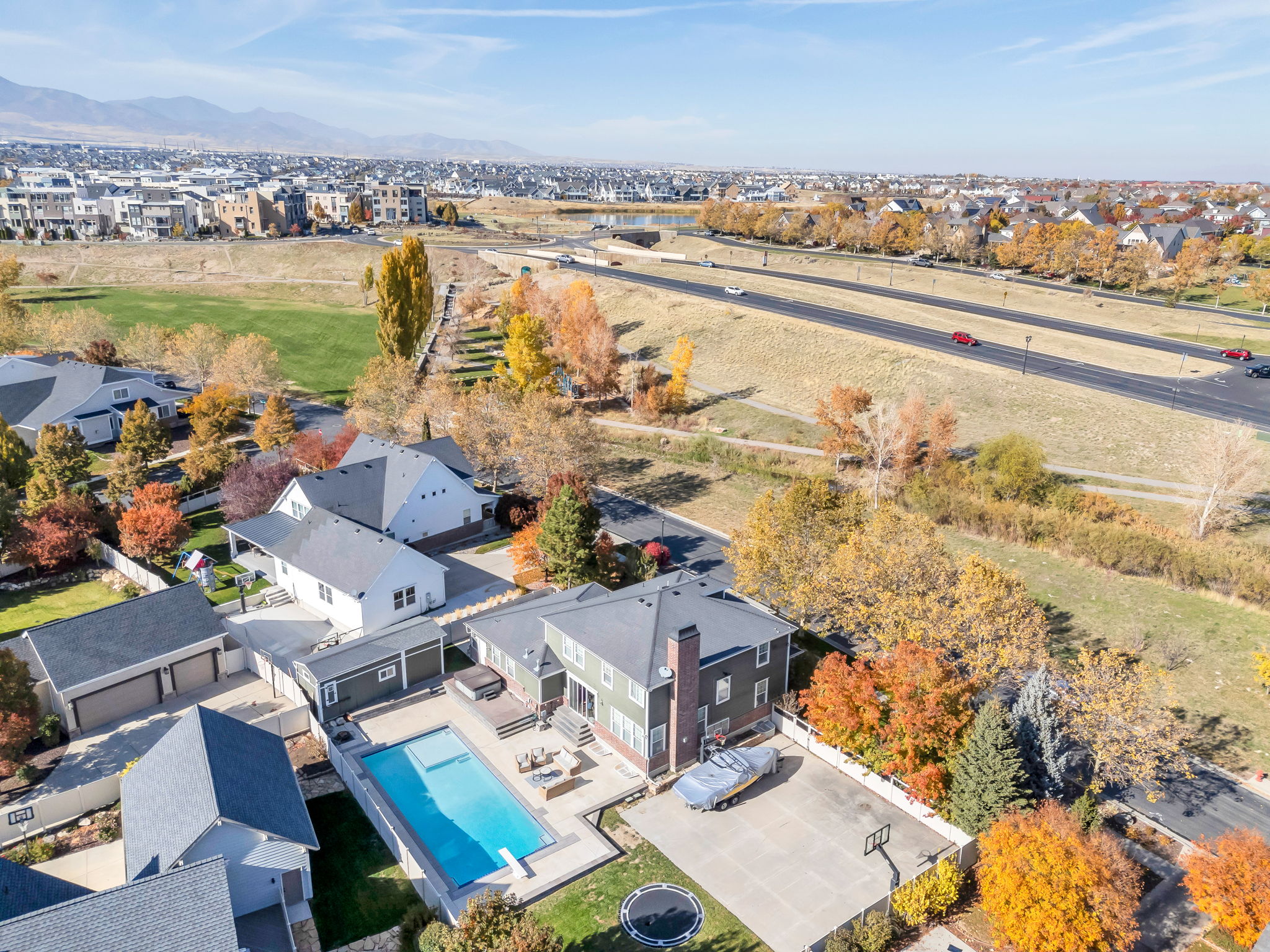 Aerial view of subject home with pool and the surrounding residential area