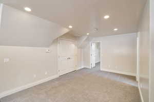 Carpeted room featuring recessed lighting, a double-door closet, and neutral wall tones