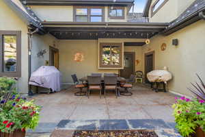 Stamped concrete, a partial overhang with string lighting, and direct exterior access