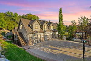 Multi-car garage structure with carriage-style doors and stone veneer accents