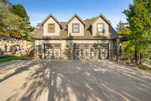 Three-car garage with decorative doors and dormer windows
