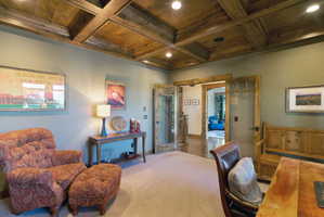 Coffered wood-panel ceiling with recessed lighting