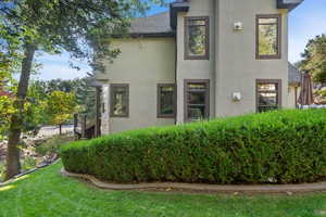 Stucco exterior with multiple windows featuring dark trim