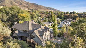 Expansive multi-level property featuring a pitched roofline, multiple dormer windows, and exterior stairs
