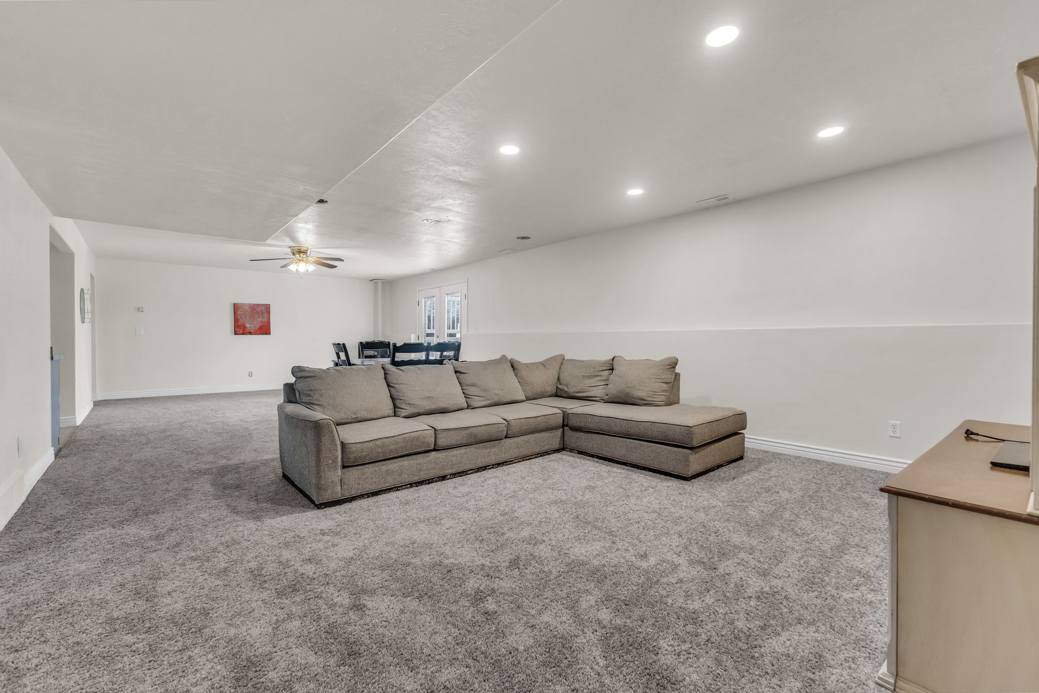 Spacious interior featuring neutral carpeting and white walls