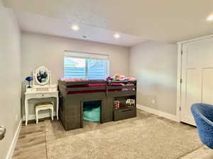 Spacious room featuring neutral paint, recessed lighting, and a large window with blinds
