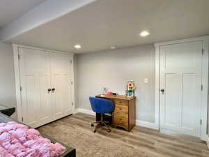 Light-toned wood-finish flooring complements the neutral wall color