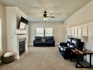 Spacious living area featuring a built-in fireplace with a tiled surround, a white mantel, and integrated shelving