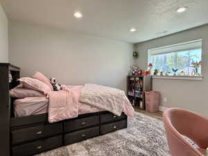 Bedroom featuring a large window, recessed lighting, and light gray wall paint