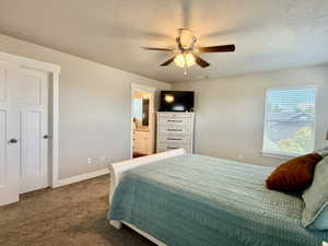 Bedroom featuring neutral wall tones and textured carpeting